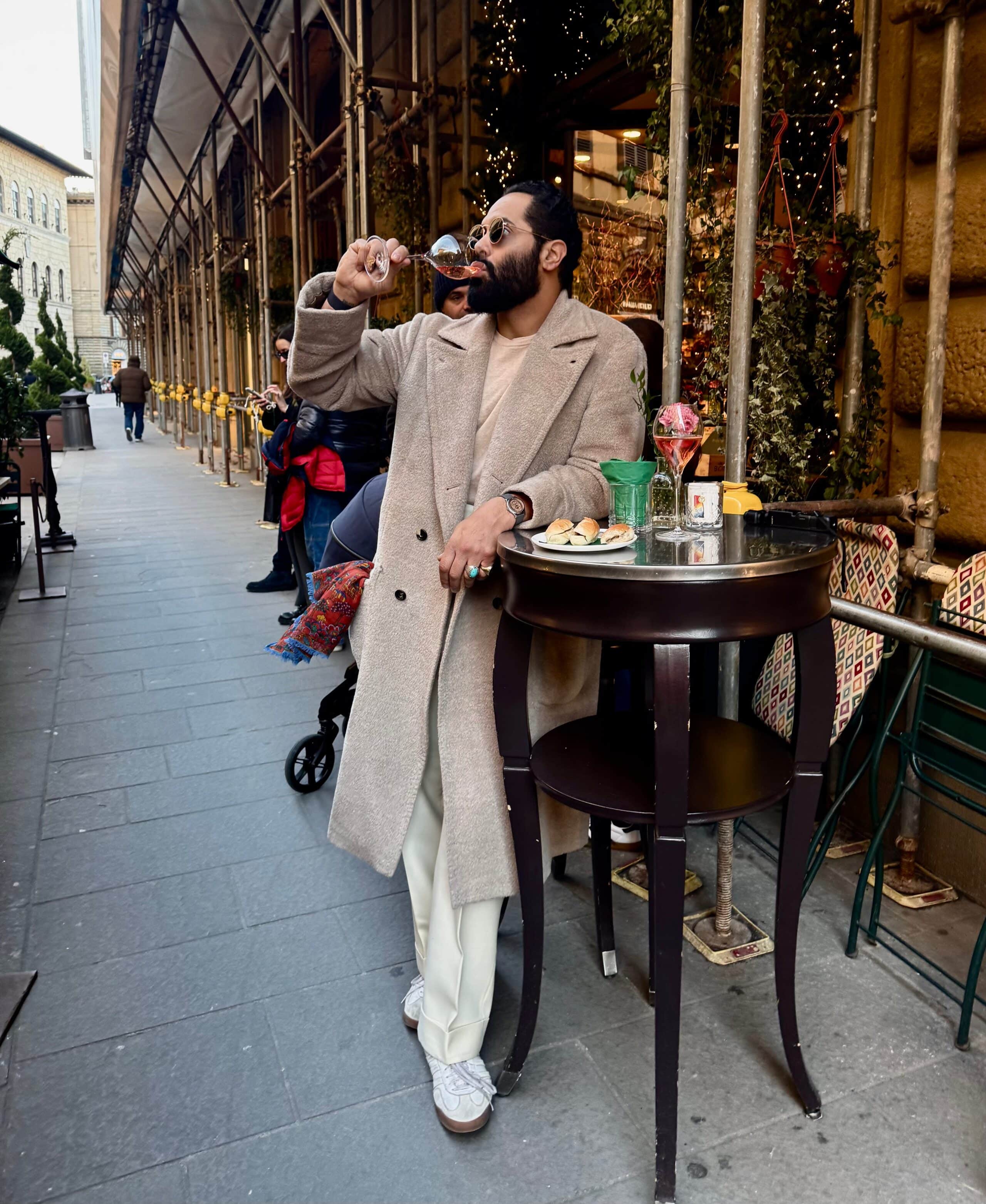 Angel Ramos drinking wine and exploring hidden gems in Florence before Pitti Uomo 2025.
